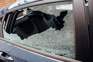 photo of a car window that has been broken into