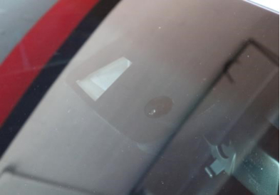 close up photo of a GM windshield with a rain sensor