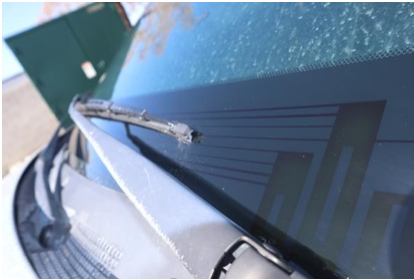 close up photo of a windshield with a heated wiper feature