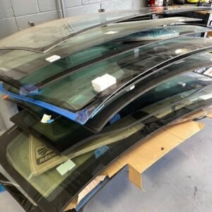 a stack of new windshields ready for installation